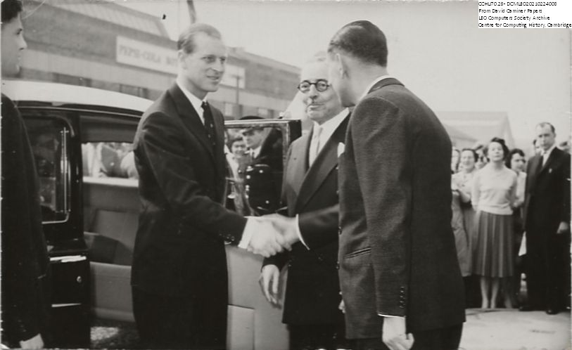 Prince Philip is greeted by Isidore M.Gluckstein (from left), Chairman of J. Lyons & Co., and Anthony Salmon at Cadby Hall